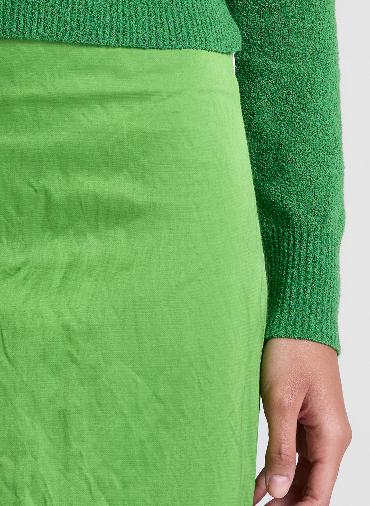woman wearing green top and green skirt