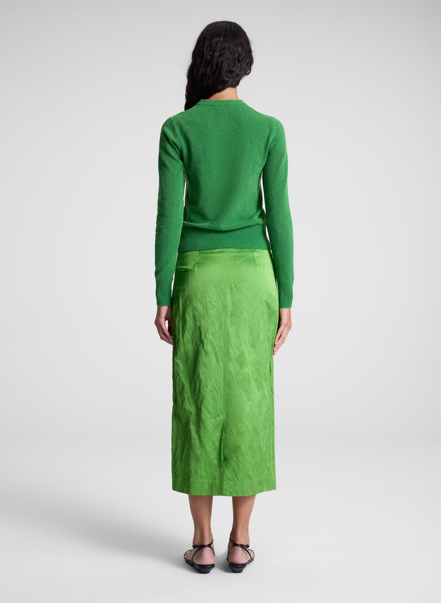 woman wearing green top and green skirt