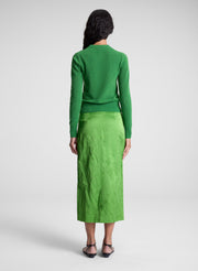 woman wearing green top and green skirt