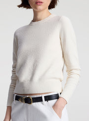 woman wearing off white sweater and white denim jeans