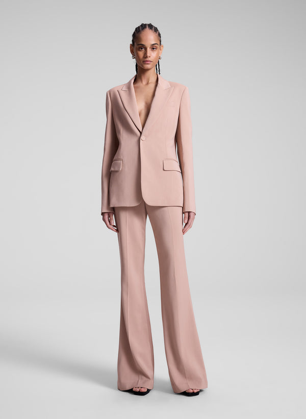 woman wearing blush colored suit