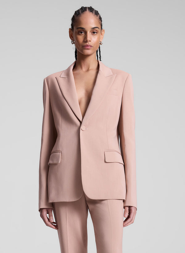 woman wearing blush colored suit