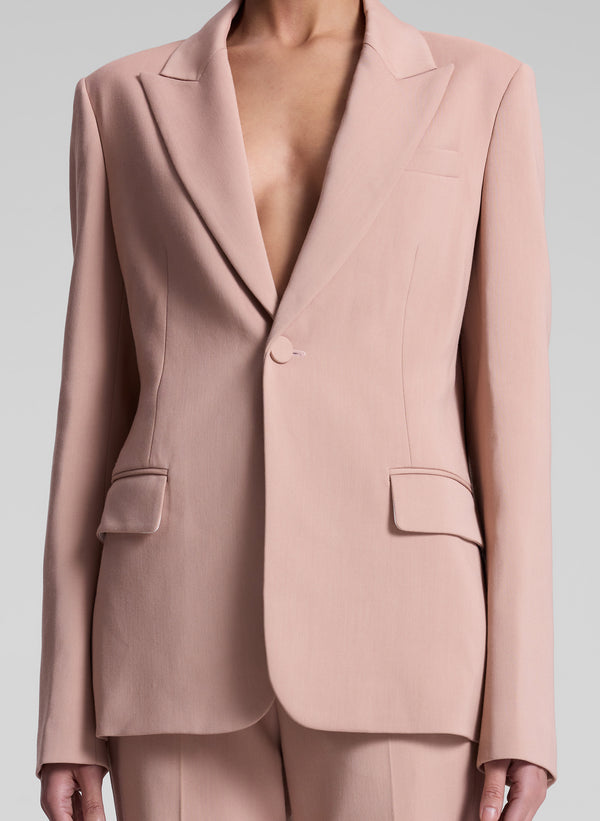 woman wearing blush colored suit