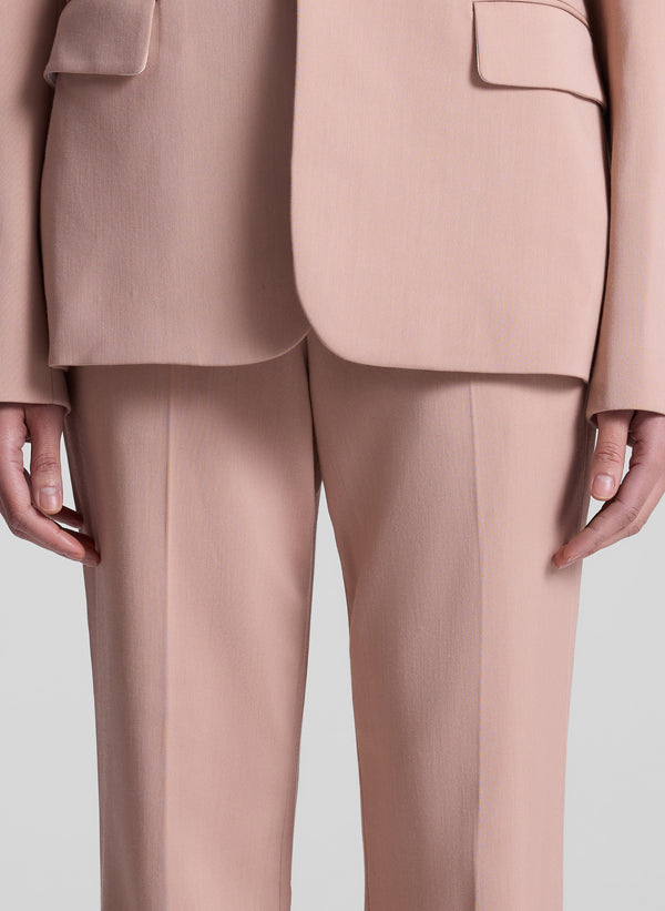 woman wearing blush colored suit