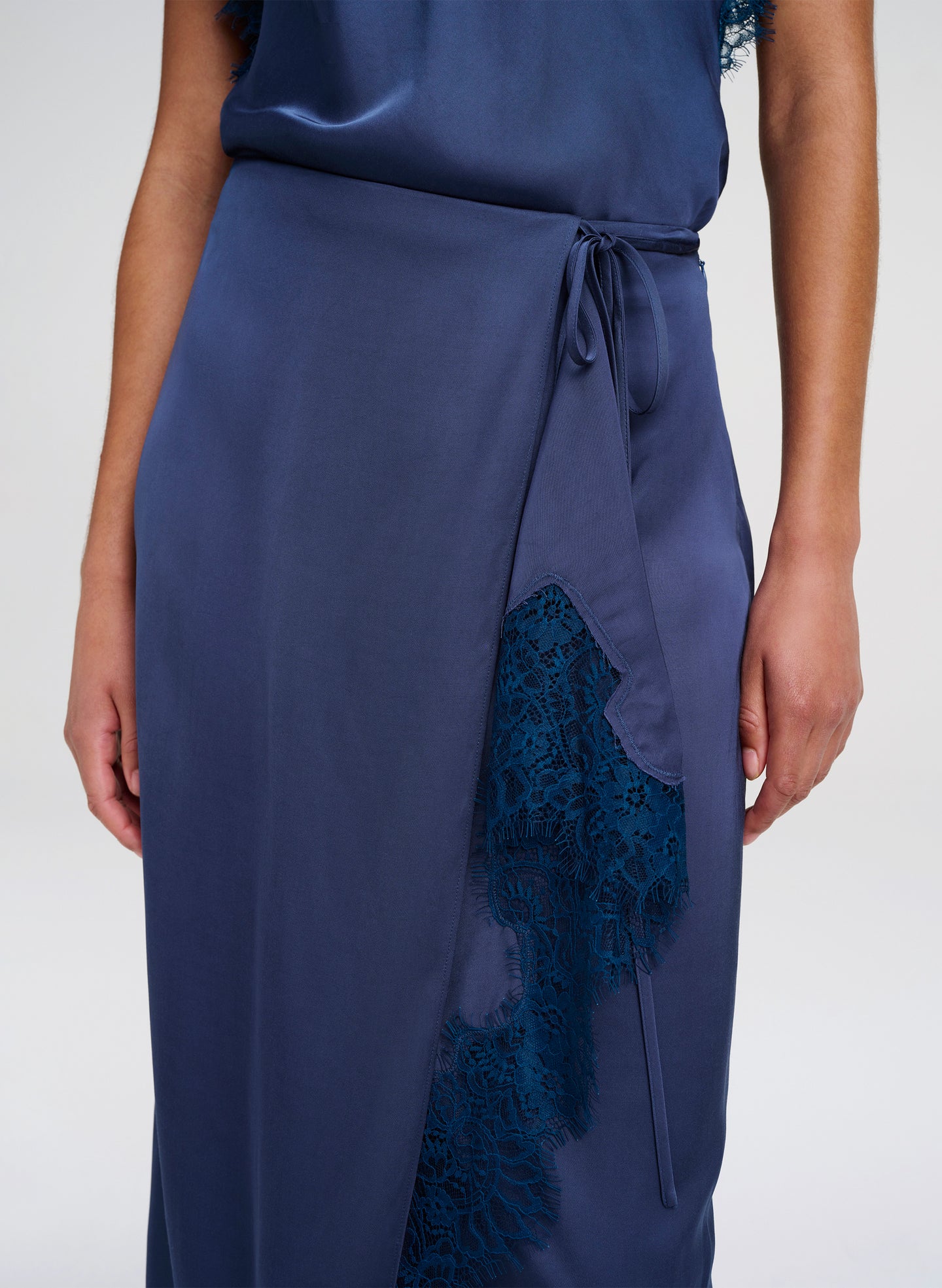Navy blue skirt with lace detailing on a white background