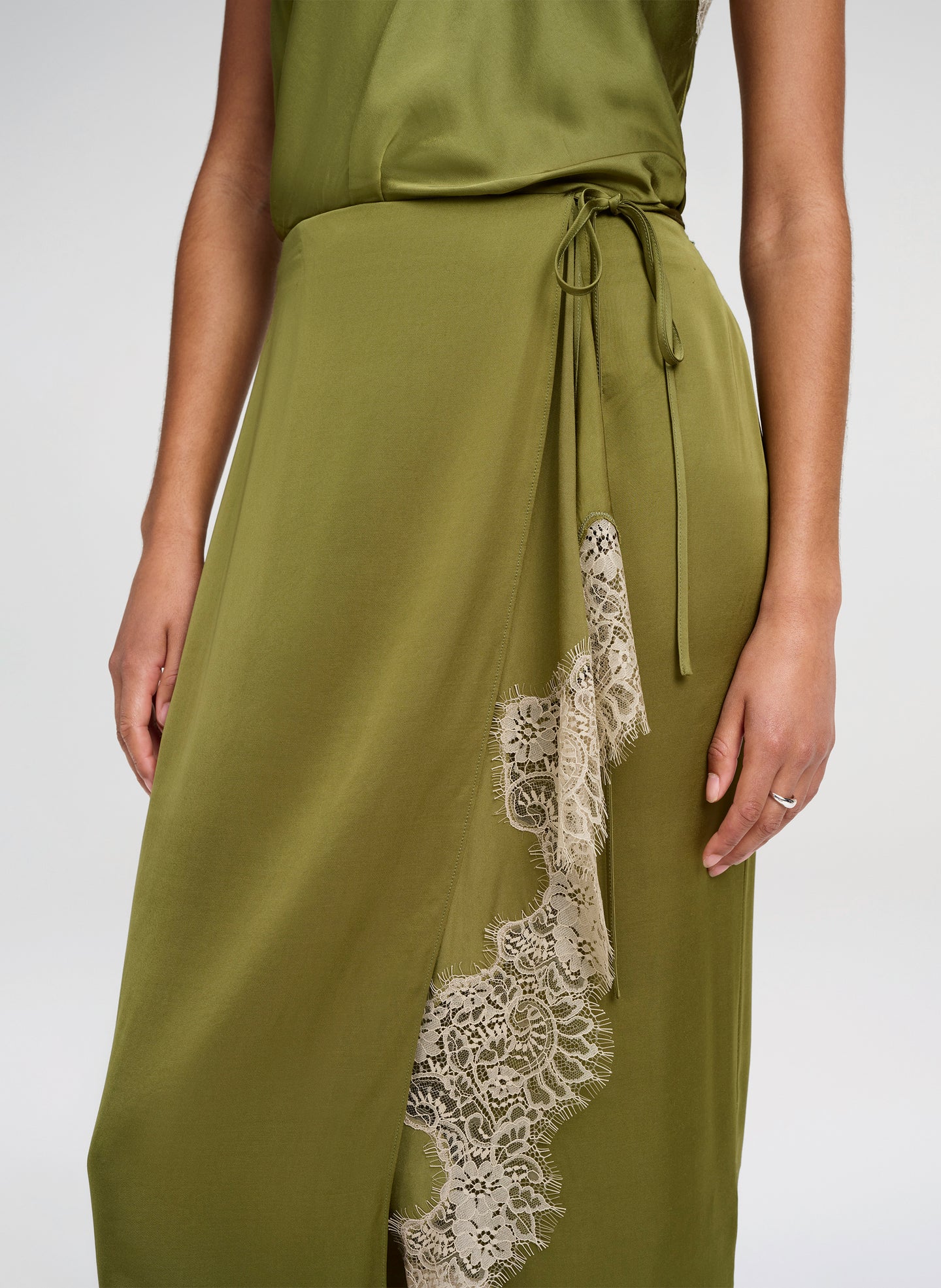 Green skirt with lace detail on a white background