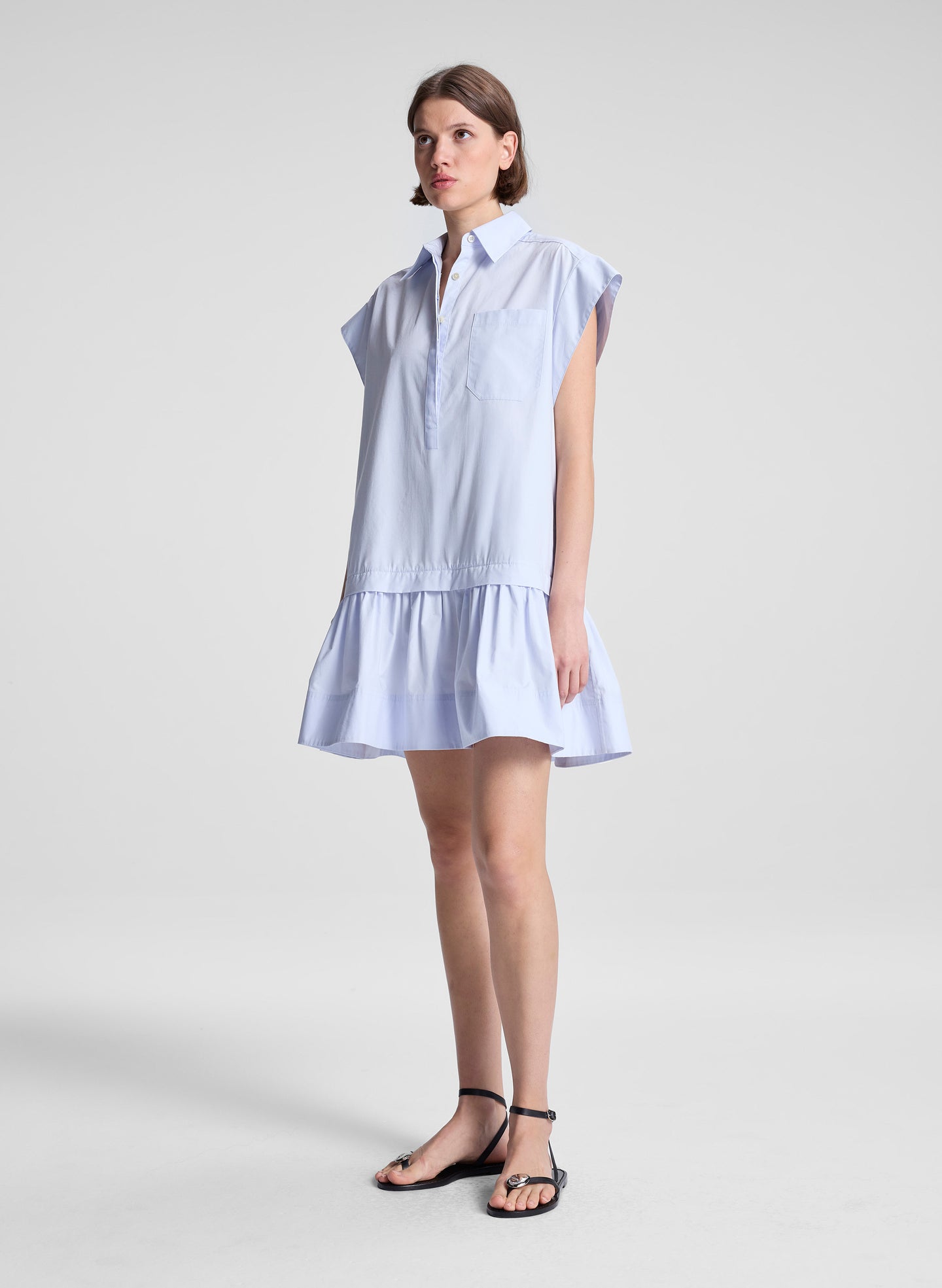 woman wearing light blue drop waist mini dress