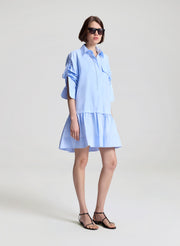 woman wearing light blue mini shirtdress