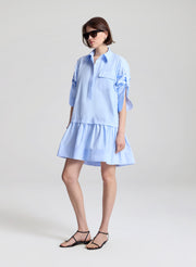 woman wearing light blue mini shirtdress
