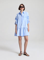 woman wearing light blue mini shirtdress