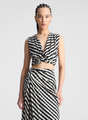 woman wearing black plaid gingham crop top and midi skirt set