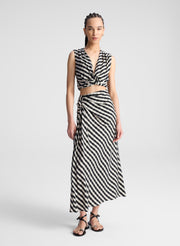 woman wearing white and black plaid gingham crop top and matching midi skirt