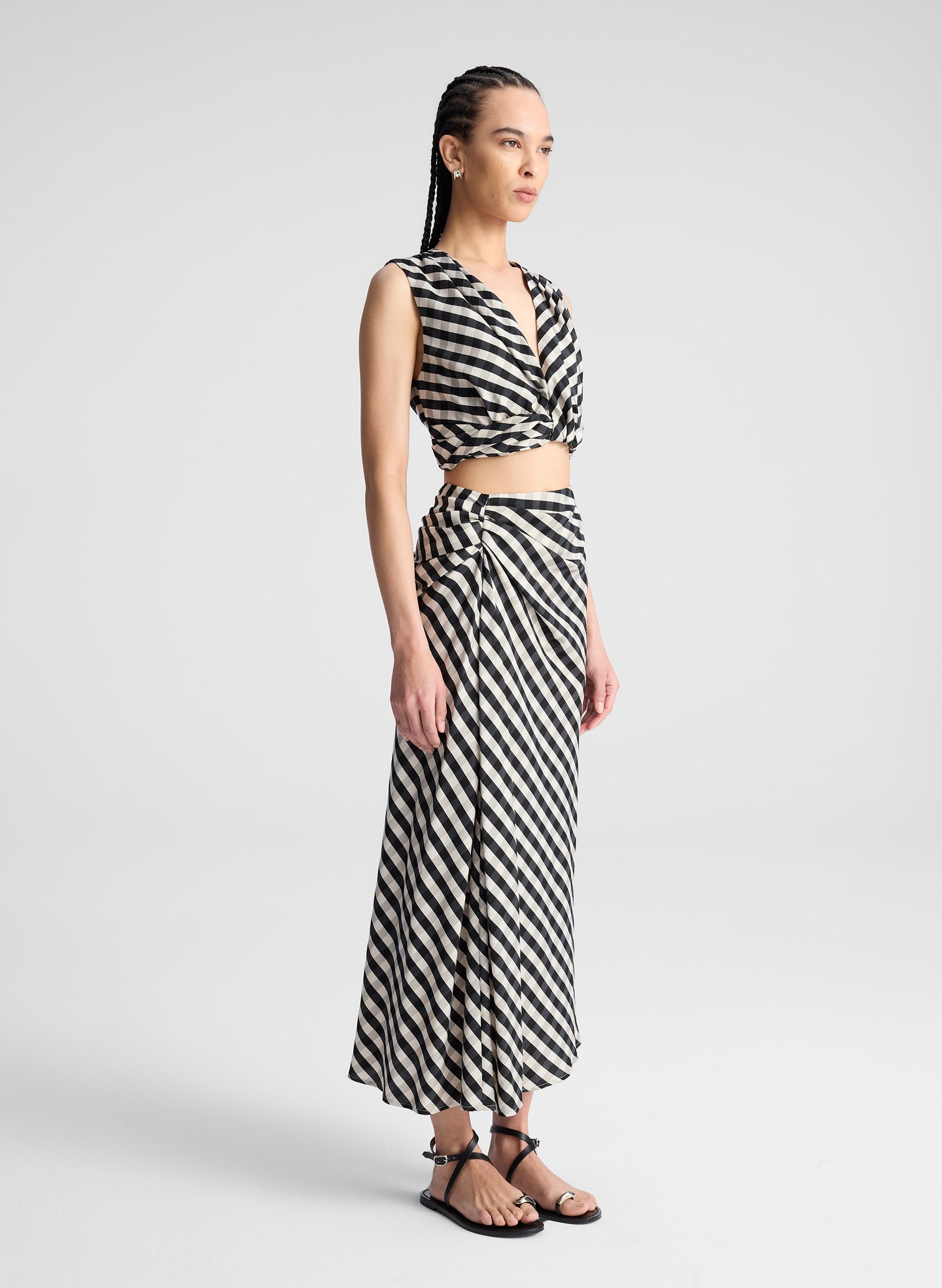 woman wearing black plaid gingham crop top and midi skirt set