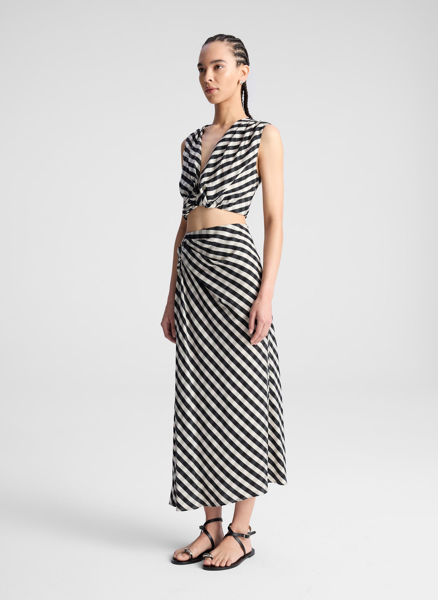 woman wearing white and black plaid gingham crop top and matching midi skirt