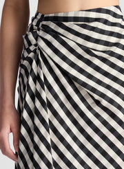 woman wearing white and black plaid gingham crop top and matching midi skirt