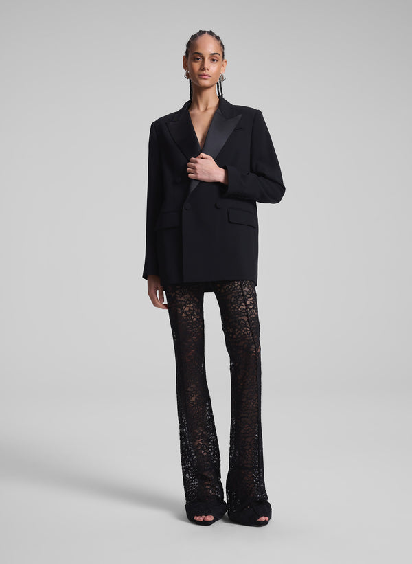 woman wearing oversized tux jacket and black lace pants