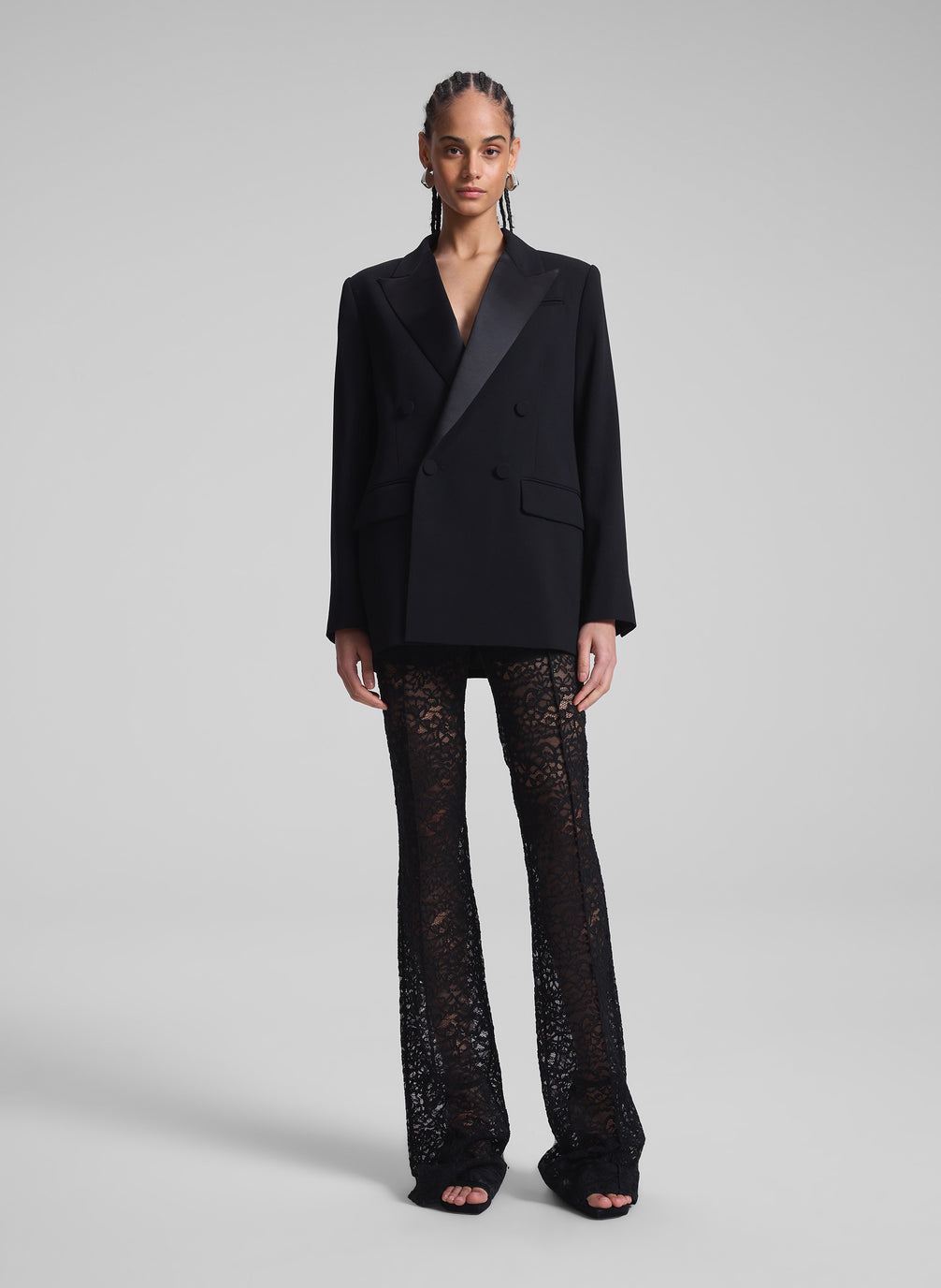 woman wearing oversized tux jacket and black lace pants