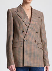 Brown checkered blazer worn by a person on a light gray background