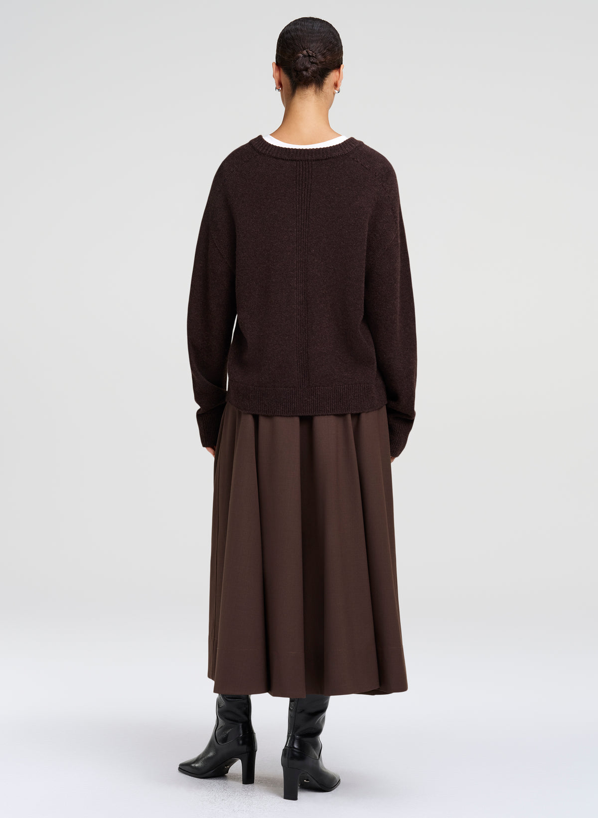 woman wearing brown sweater and brown skirt