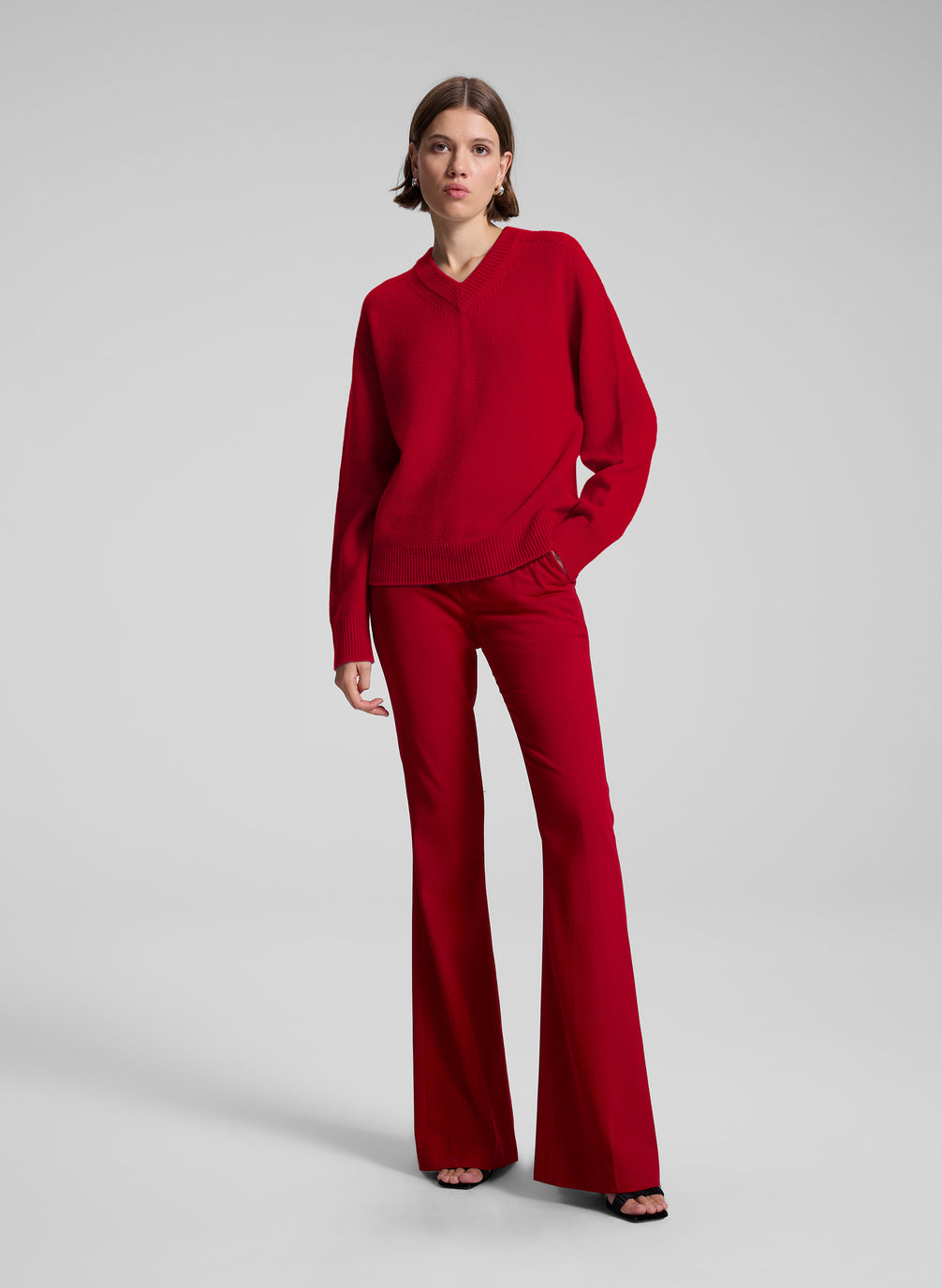 woman wearing red v neck sweater and red pants