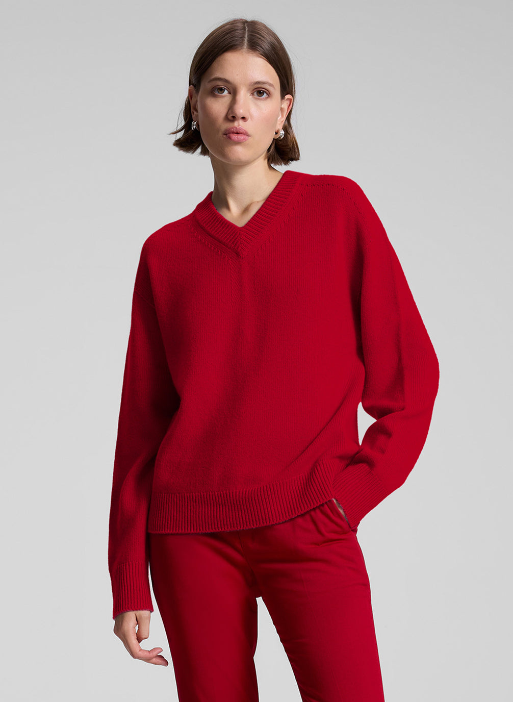 woman wearing red v neck sweater and red pants