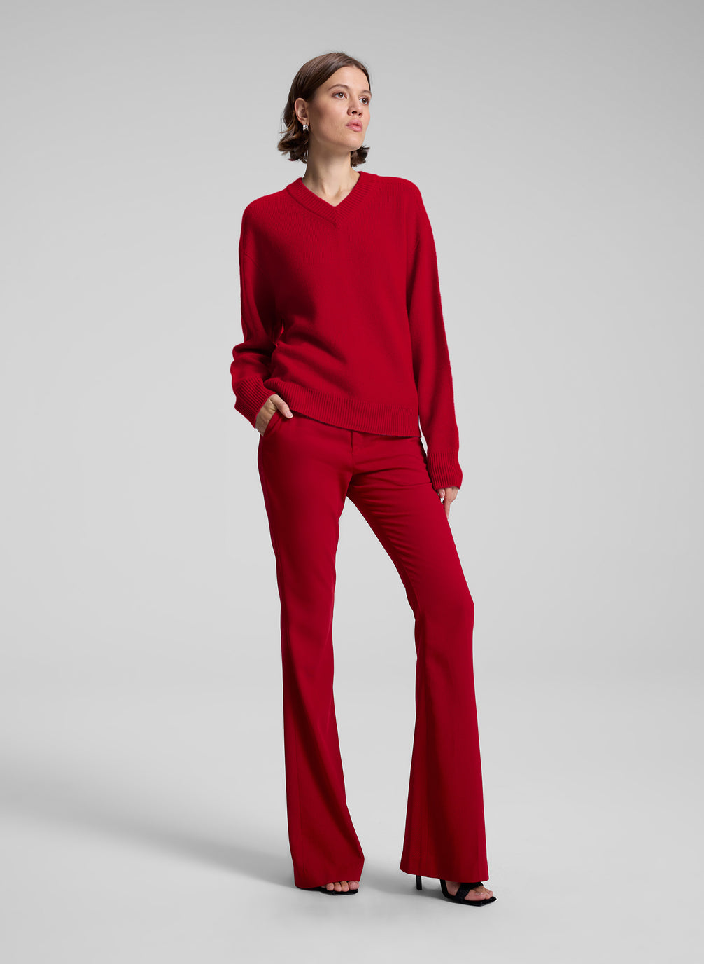 woman wearing red v neck sweater and red pants