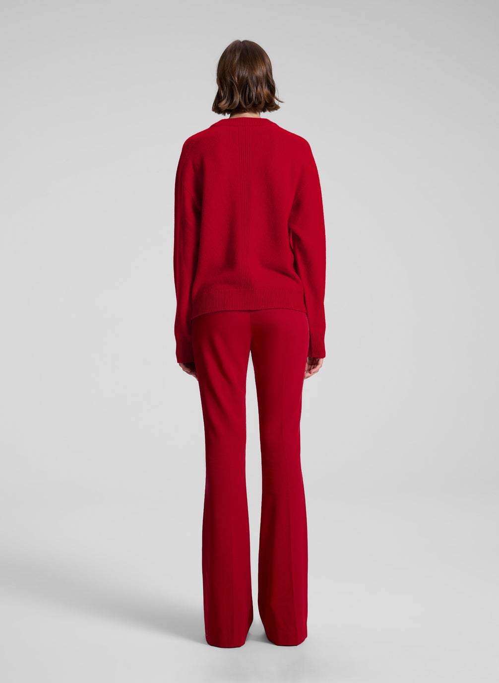 woman wearing red v neck sweater and red pants