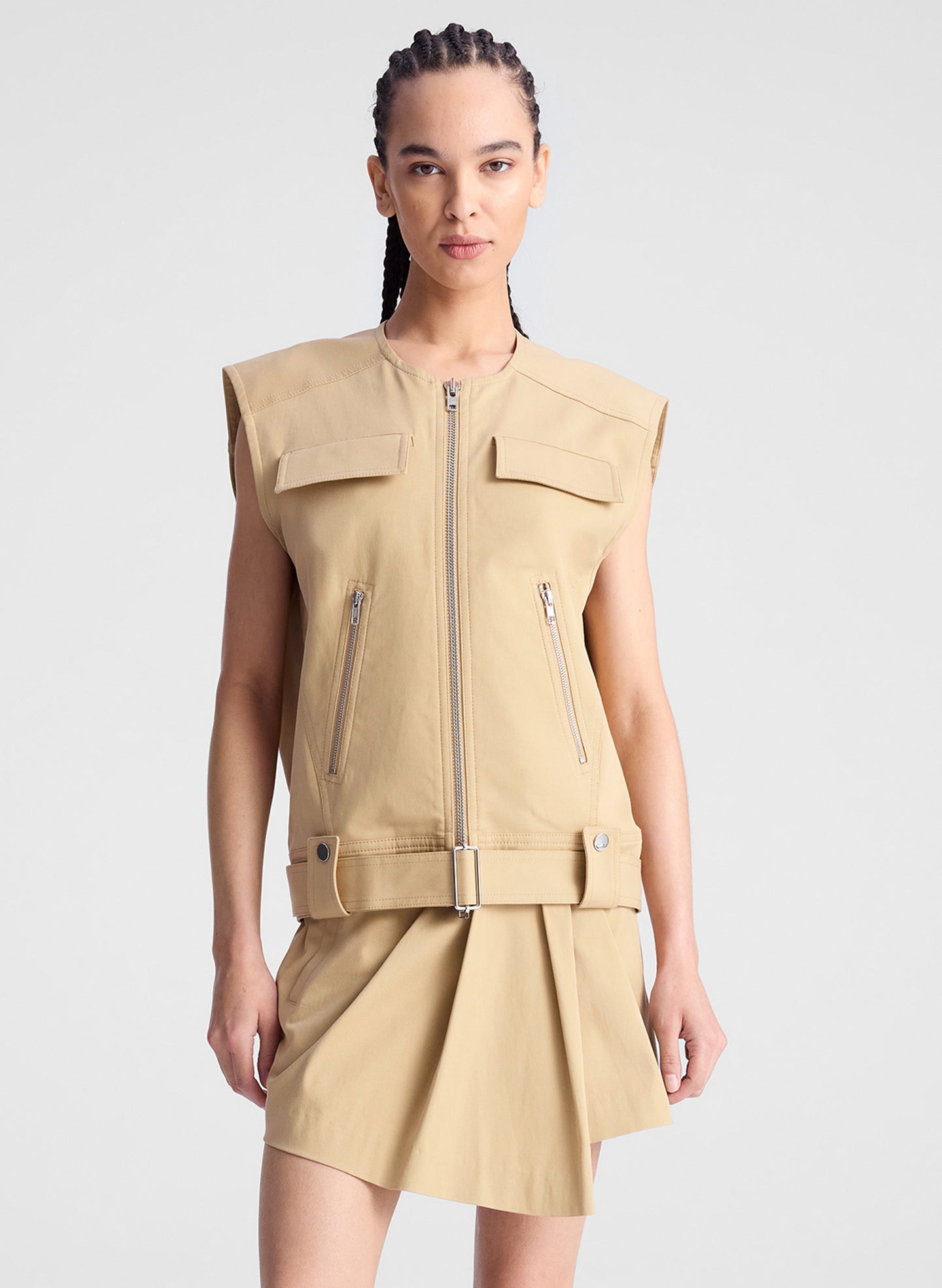 woman wearing beige sleeveless jacket and matching skort