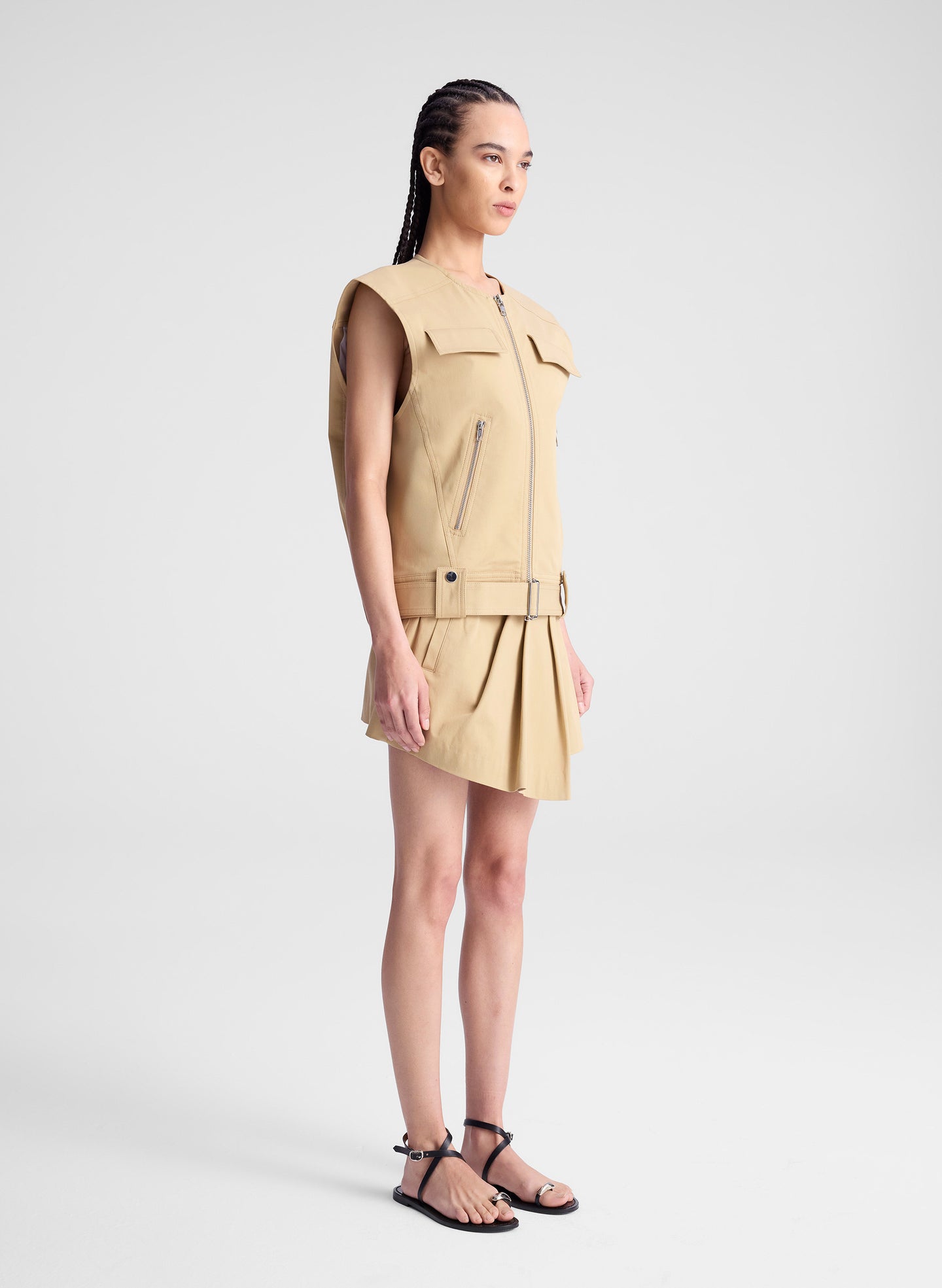 woman wearing beige sleeveless jacket and matching skort