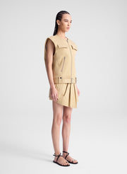 woman wearing beige sleeveless jacket and matching skort