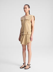 woman wearing beige sleeveless jacket and matching skort