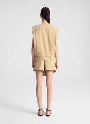 woman wearing beige sleeveless jacket and matching skort