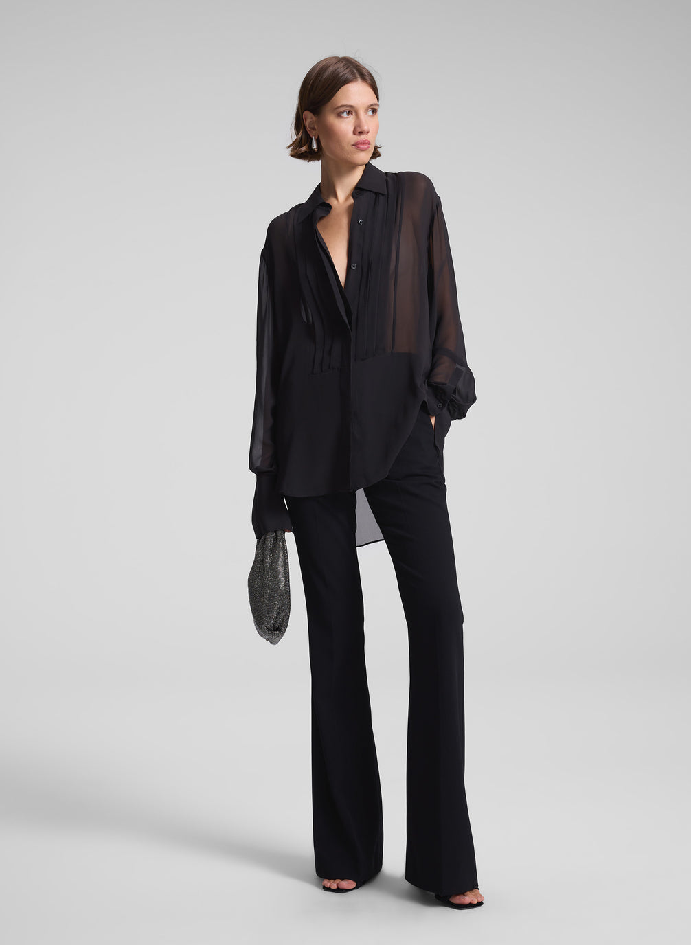 woman wearing black sheer tux top and black pants