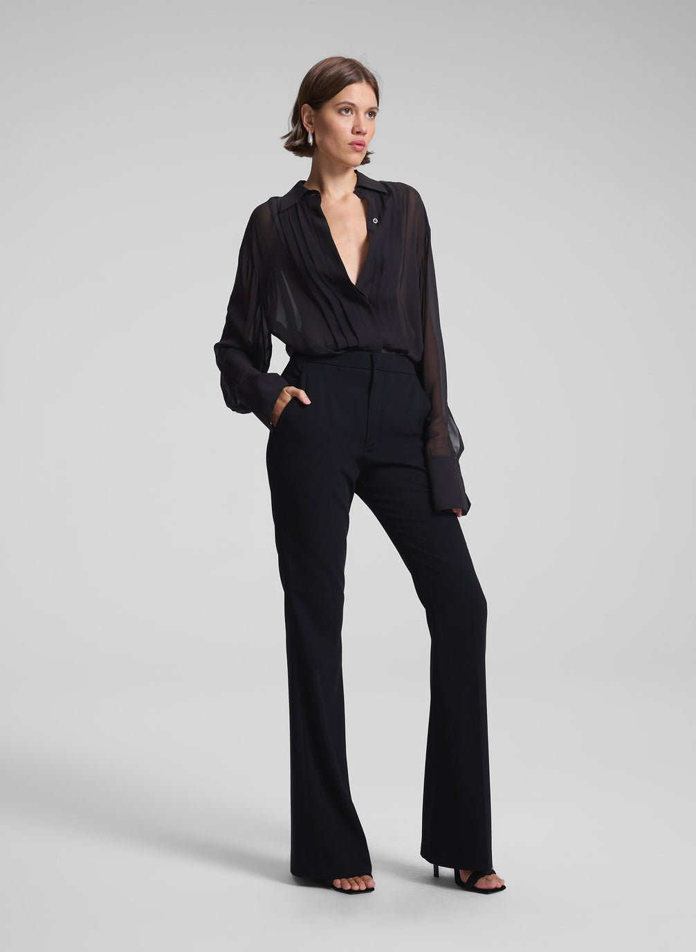 woman wearing black sheer tux top and black pants