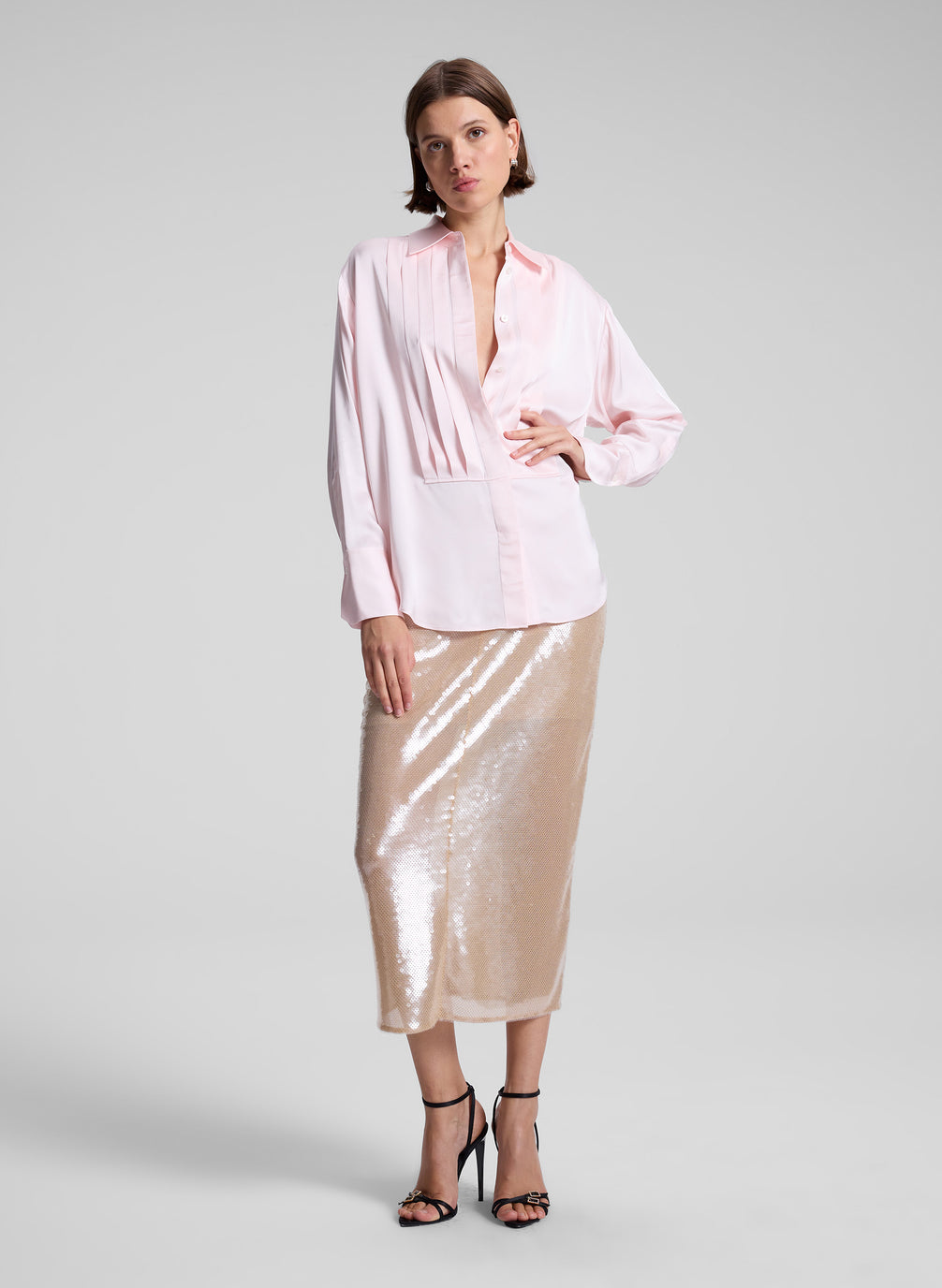 woman wearing pink shirt and sequined midi skirt