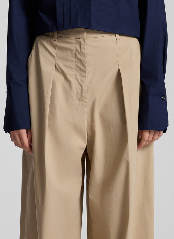 woman wearing tan pants and navy blue shirt