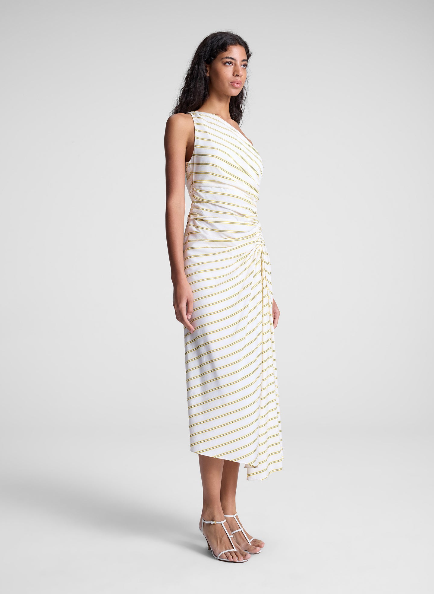 woman wearing yellow striped one shoulder dress