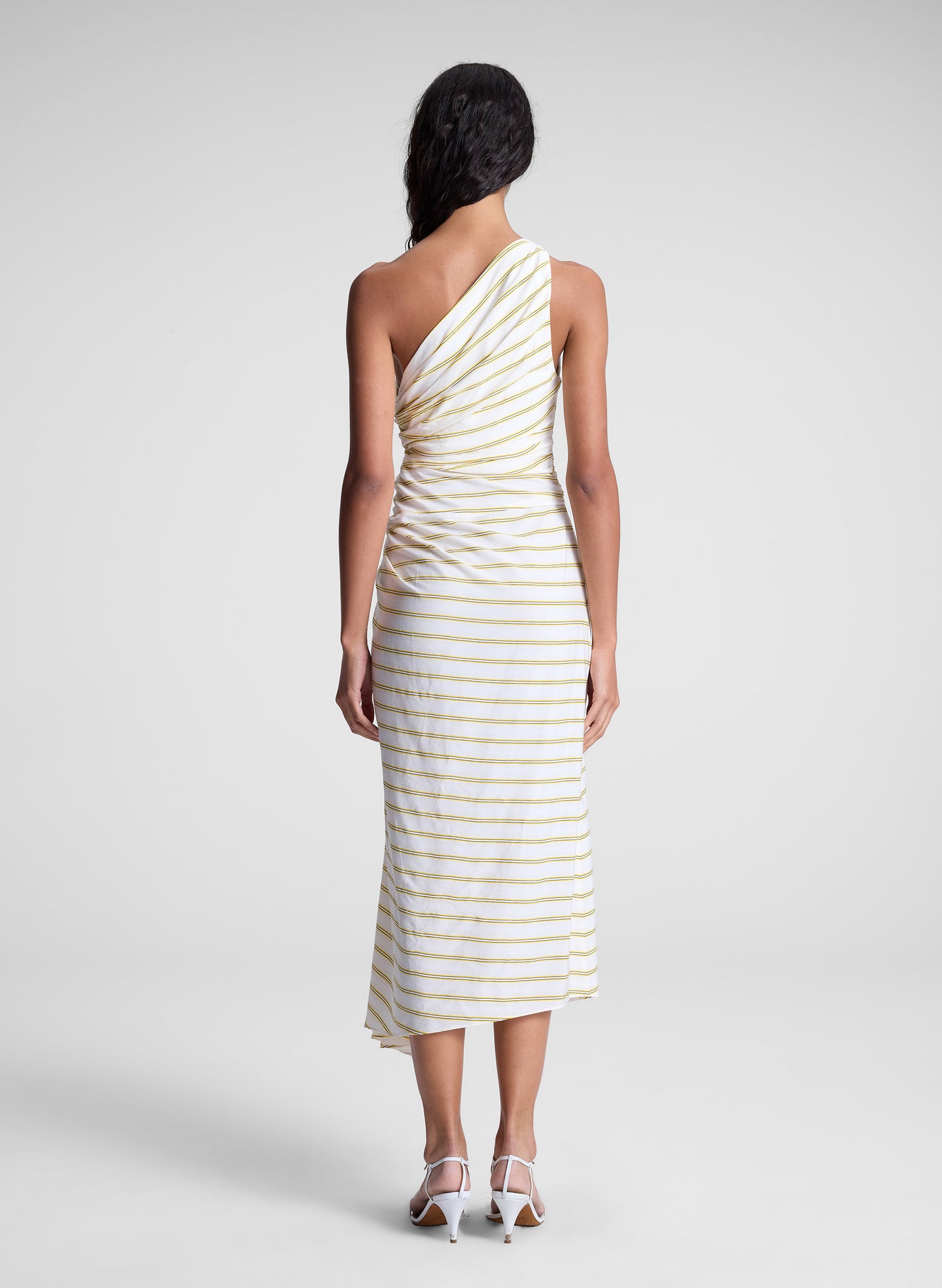 woman wearing yellow striped one shoulder dress