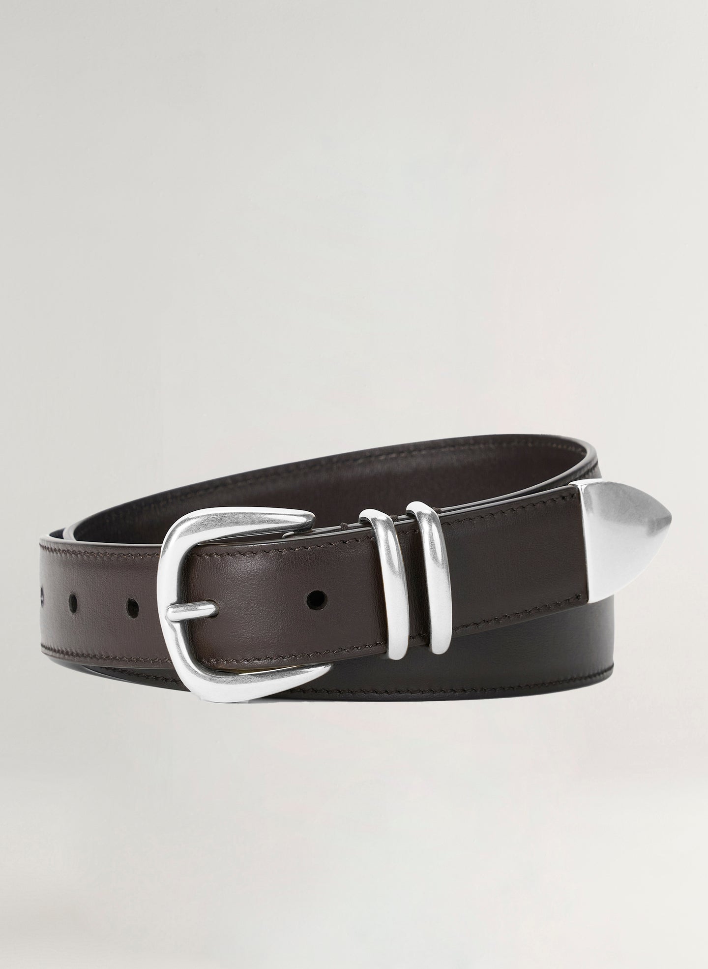 Brown leather belt with silver buckle on a light gray background