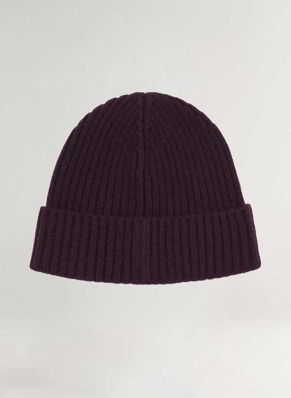 Dark purple ribbed knit beanie on a light gray background