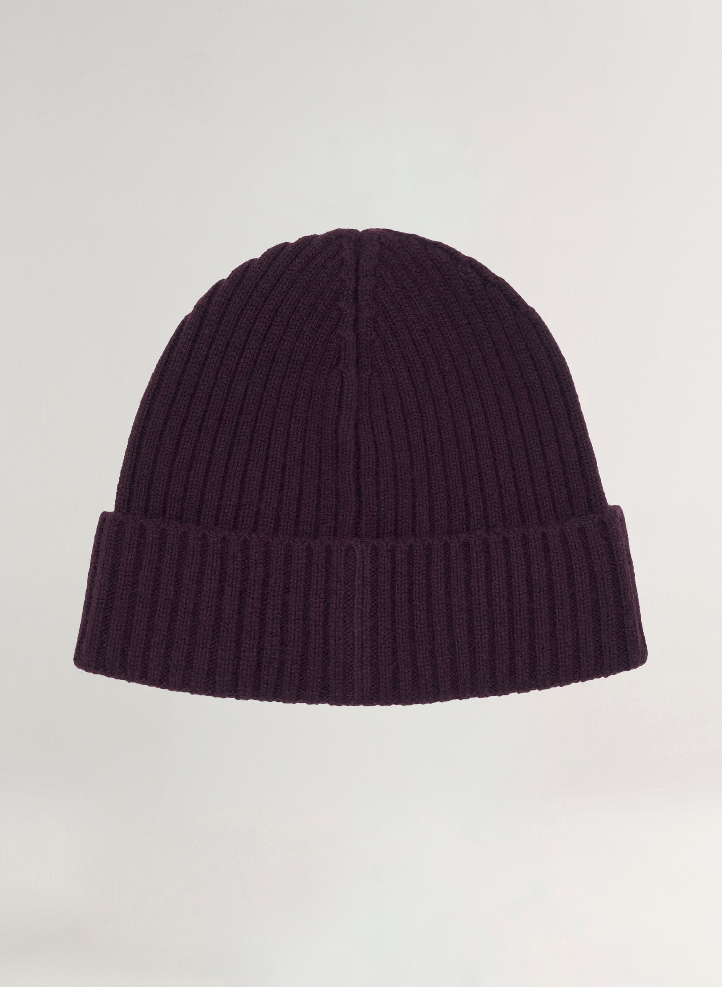 Dark purple ribbed knit beanie on a light gray background