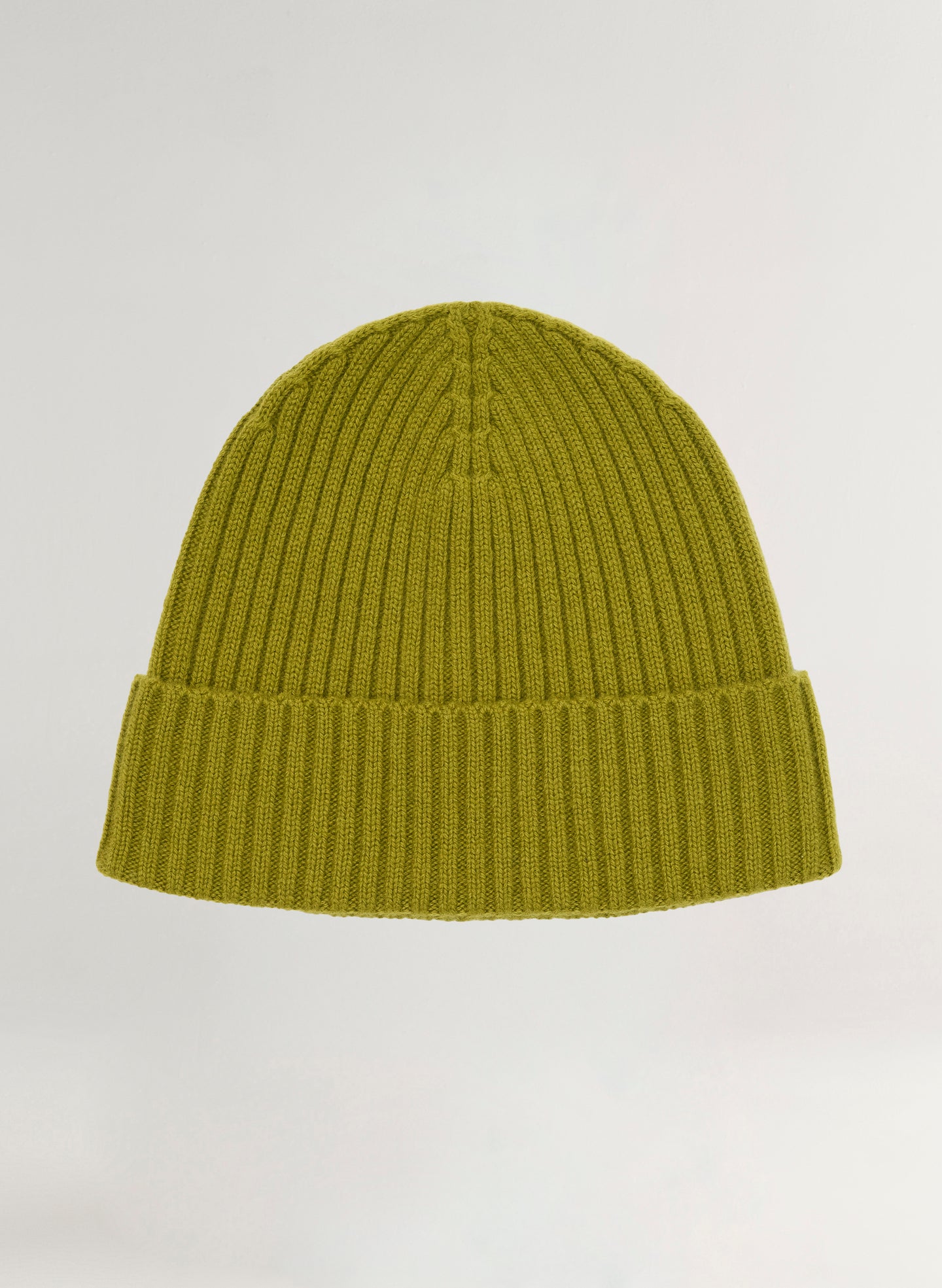 Green knit beanie on a light gray background