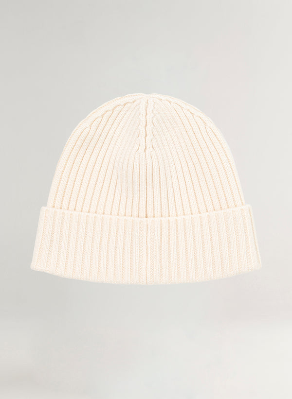 White knit beanie on a light gray background