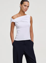 woman wearing white top and blue pants