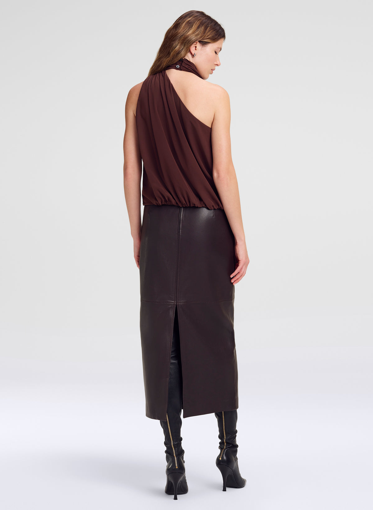 woman wearing brown top and maroon leather midi skirt