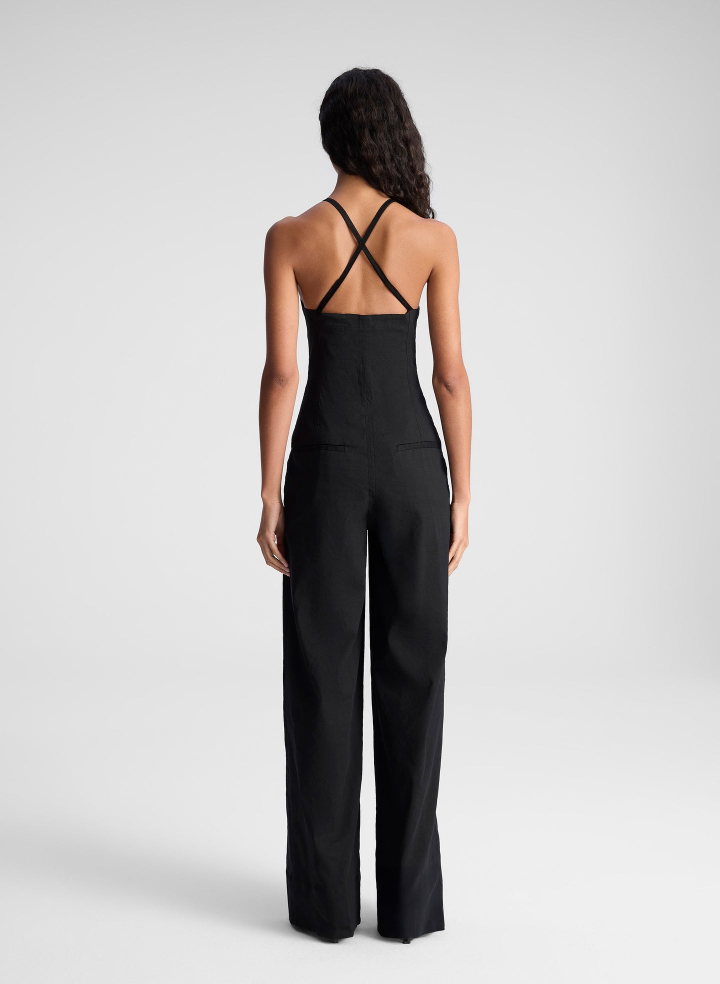 woman wearing black sleeveless jumpsuit