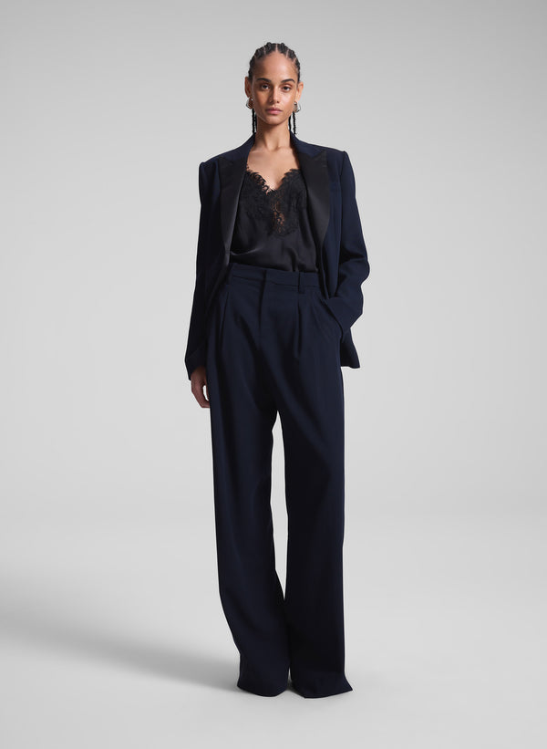 woman wearing navy blue suit with black lace camisole