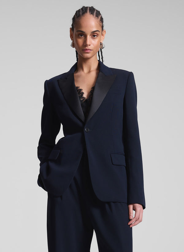 woman wearing navy blue suit with black lace camisole