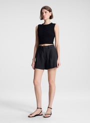 woman wearing black sleeveless top and black linen shorts