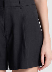 woman wearing black sleeveless top and black linen shorts